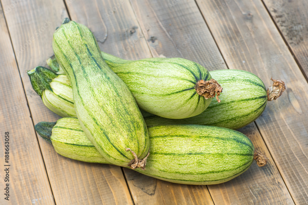 green zucchini on a old wooden board green zucchini on a old wooden board