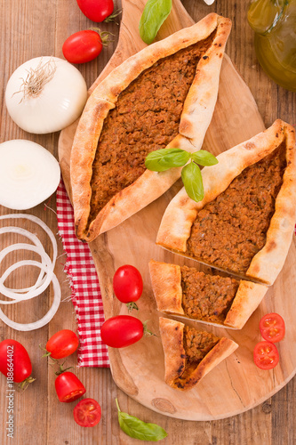 Turkish pide pizza with meat and onion. 