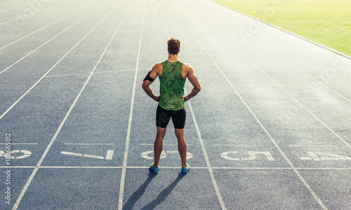 Sprinter standing on running track