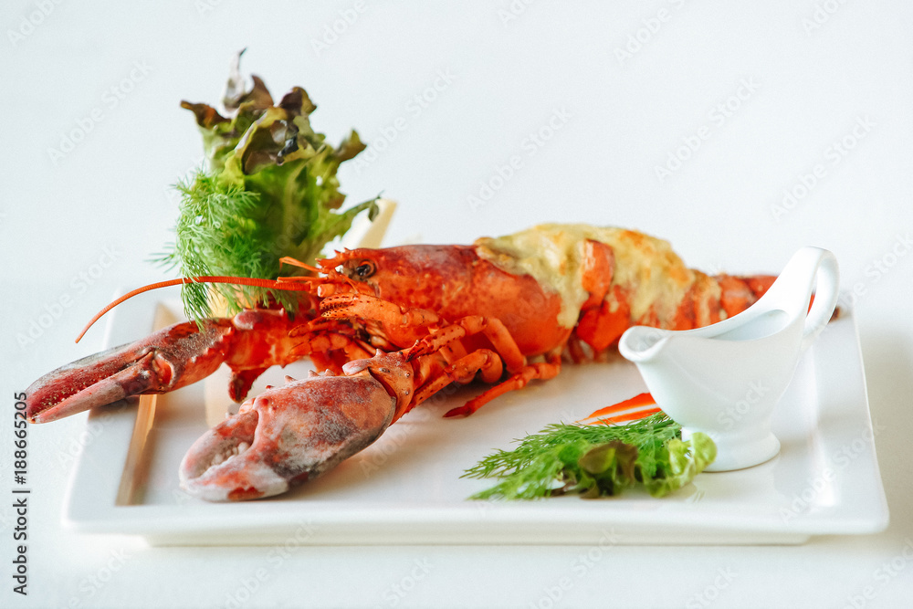 Red crab on a plate with greens. Cooked crabs on white plate Red crab on a plate with greens. Cooked crabs on white plate