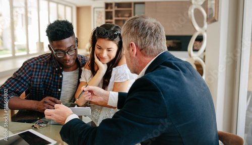 Realtor explaining lease agreement to a couple