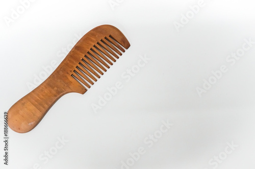 isolated wooden comb for woman hair and beauty