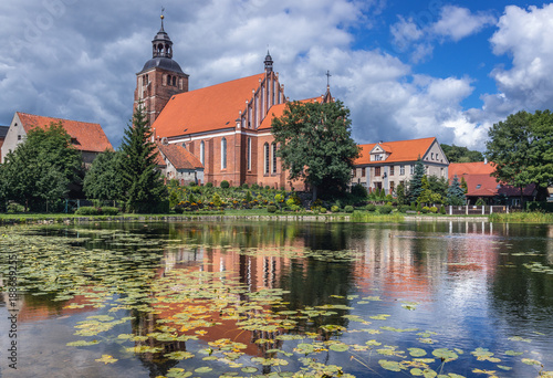 Pond on Pisa River and Saints Anne and Stephen Catholic Church in Barczewo, small city near Olsztyn, Masuria region of Poland