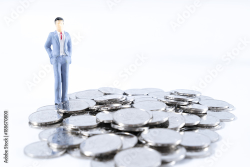 Business startup calculating concept. Businessman thinking or making decision with calculator and coins stack.