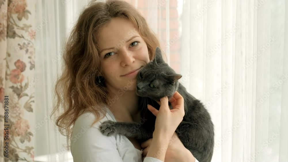 young woman with her lovely grey cat, white background young woman with her lovely grey cat, white background