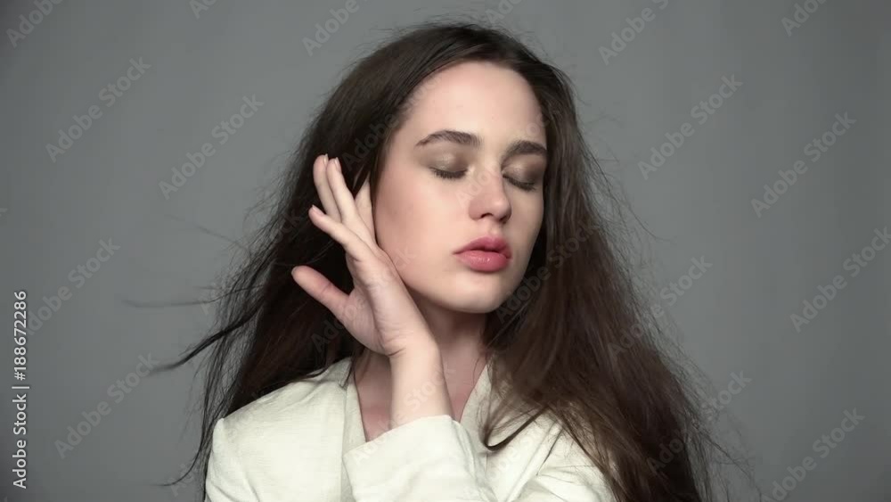 Slow motion video portrait of beauty young brunette woman with green eyes and streaming hair Slow motion video portrait of beauty young brunette woman with green eyes and streaming hair