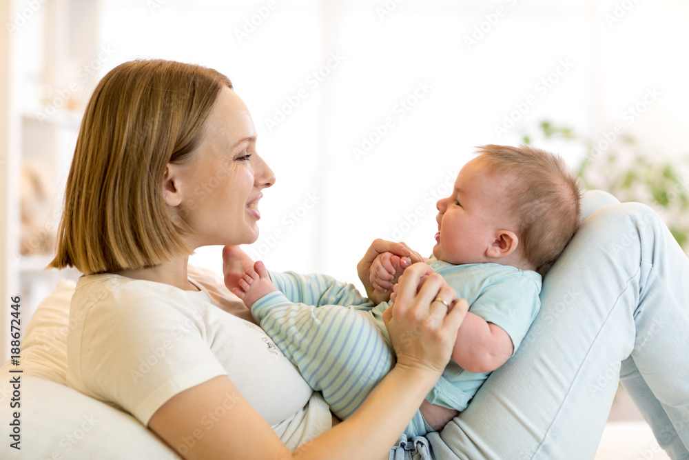 Mother and baby son smiling and playing Mother and baby son smiling and playing