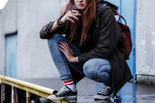 Teenage girl smoking cigarette photo