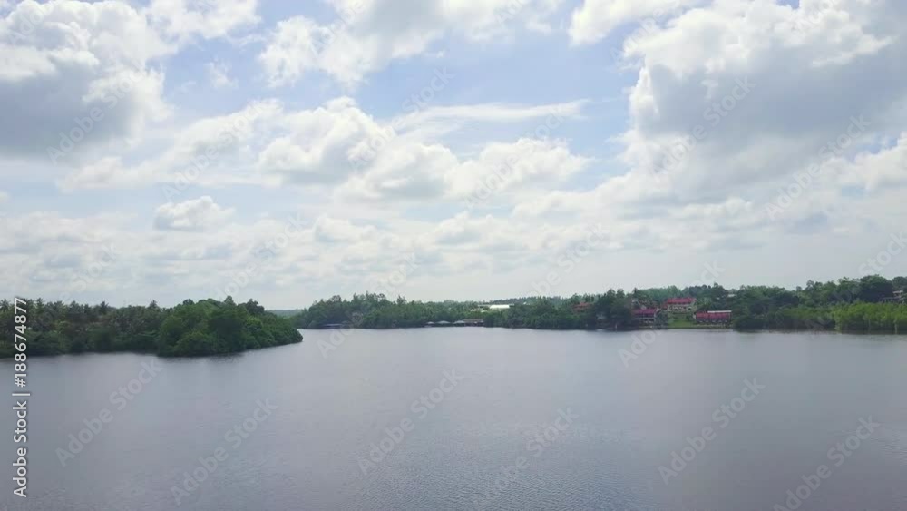 Aerial view over the smooth water island lake sunrise at ceylon drone footage Aerial view over the smooth water island lake sunrise at ceylon drone footage