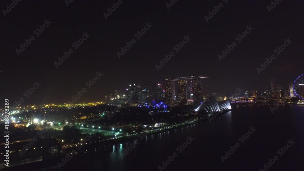 Fascinating 4k aerial drone view on big city Singapore by ocean metropolis downtown in bright night light illumination Fascinating 4k aerial drone view on big city Singapore by ocean metropolis downtown in bright night light illumination