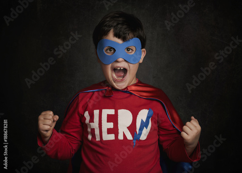 superhero. niño feliz disfrazado de superheroe  photo