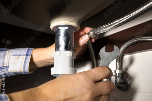 plumber woman installing sink in the bathroom