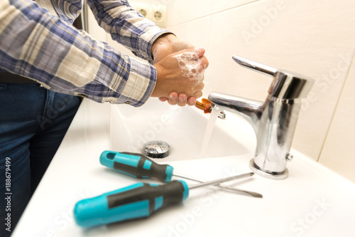 electrician woman washes his hands after work