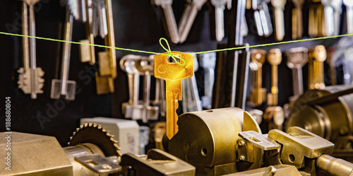 Golden key on a green twine in a locksmith workshop