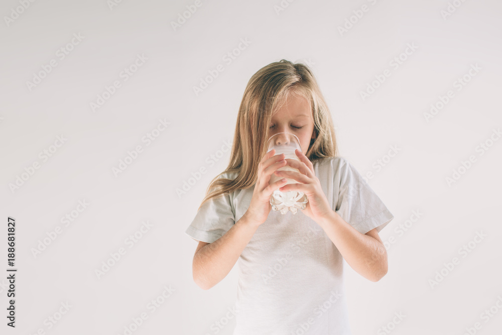 girl is drinking fresh glass of milk isoladed on white background girl is drinking fresh glass of milk isoladed on white background