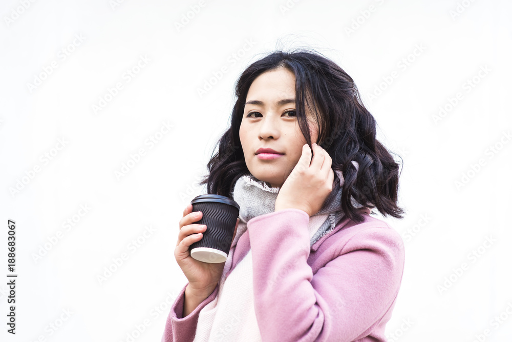 Asian woman holding paper cup of hot drink Asian woman holding paper cup of hot drink
