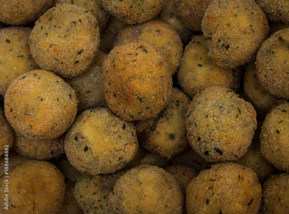 Food background of a large pile of homemade falafel balls. Traditional arabic or indian food made with chickpeas, spices and other vegetarian ingredients. Food background of a large pile of homemade falafel balls. Traditional arabic or indian food made with chickpeas, spices and other vegetarian ingredients.