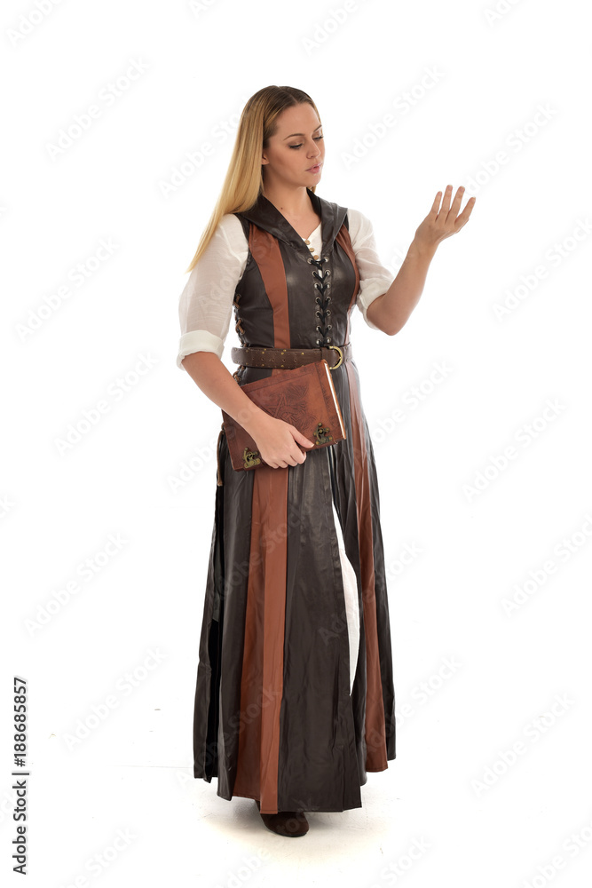 full length portrait of girl wearing brown fantasy costume, holding a book. standing pose on white studio background. full length portrait of girl wearing brown fantasy costume, holding a book. standing pose on white studio background.