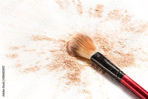 Close-up of crushed mineral shimmer powder golden color with makeup brush