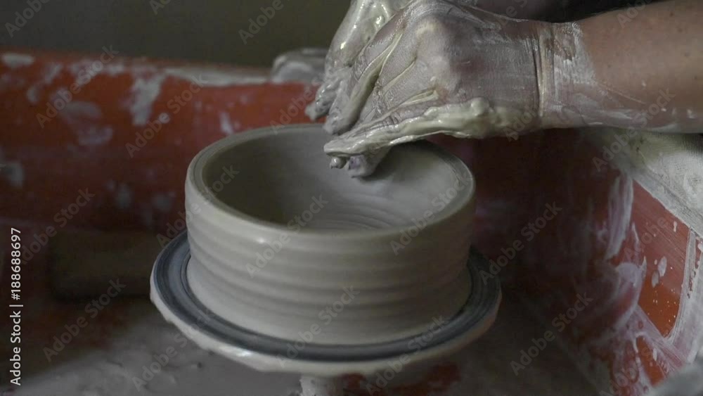 Women's hands make ceramic bowl from clay, work in a pottery workshop Women's hands make ceramic bowl from clay, work in a pottery workshop
