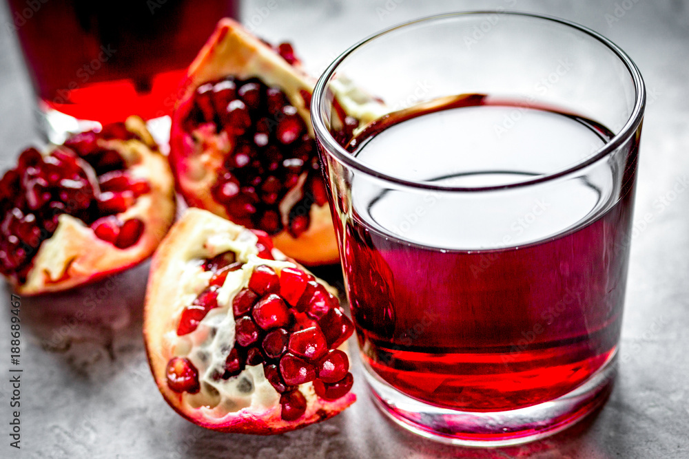 fresh pomegranate with juice in glasses on kitchen background fresh pomegranate with juice in glasses on kitchen background