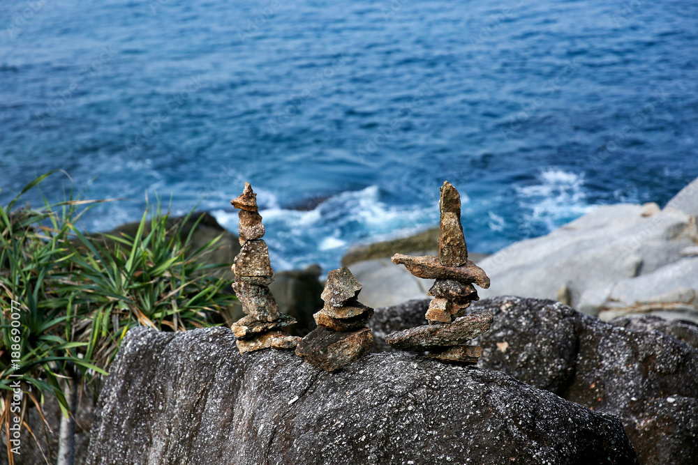 Symbolic scales of stones against the background of the sea and blue sky. Concept of harmony and balance. Pros and cons concept Symbolic scales of stones against the background of the sea and blue sky. Concept of harmony and balance. Pros and cons concept