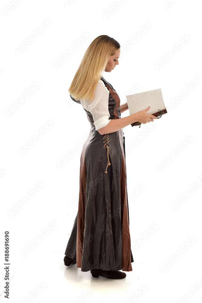 full length portrait of girl wearing brown fantasy costume, holding a book. standing pose on white studio background. full length portrait of girl wearing brown fantasy costume, holding a book. standing pose on white studio background.