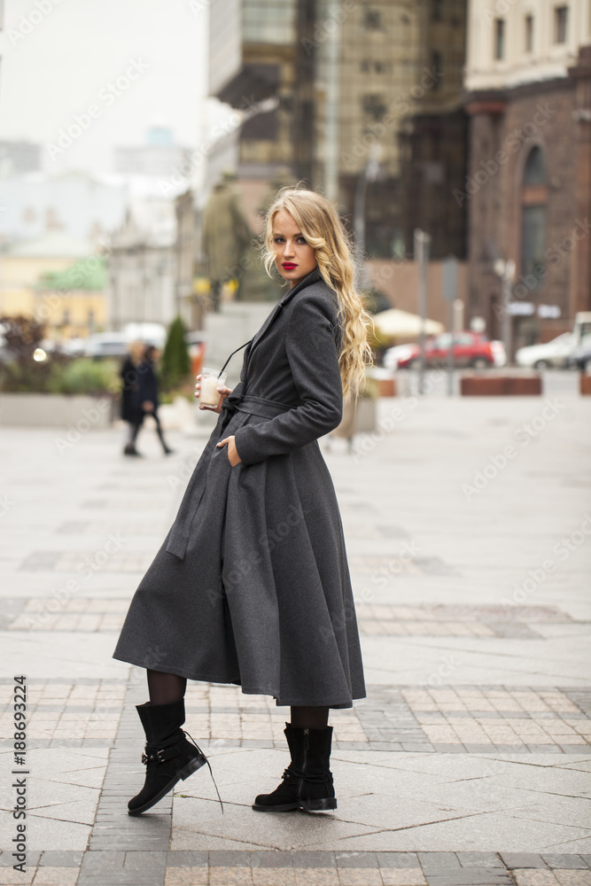 Portrait of a young beautiful woman in gray coat