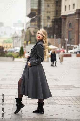 Portrait of a young beautiful woman in gray coat