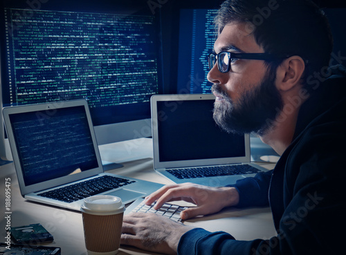 Young man hacking server in...