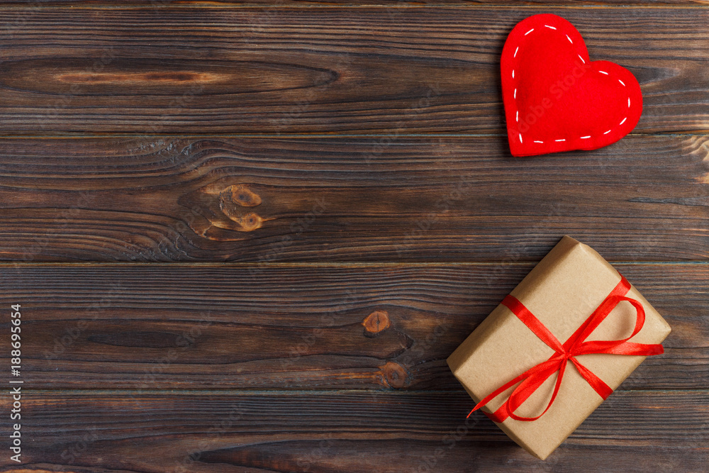 Fototapeta premium Gift box with fabric hearts on Black wooden table