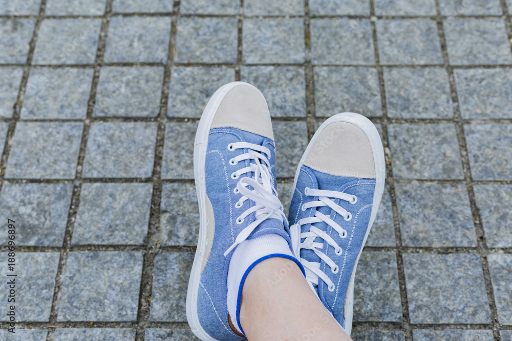 Legs and sneakers of teenage boys