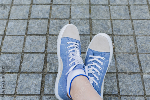 Legs and sneakers of teenage boys