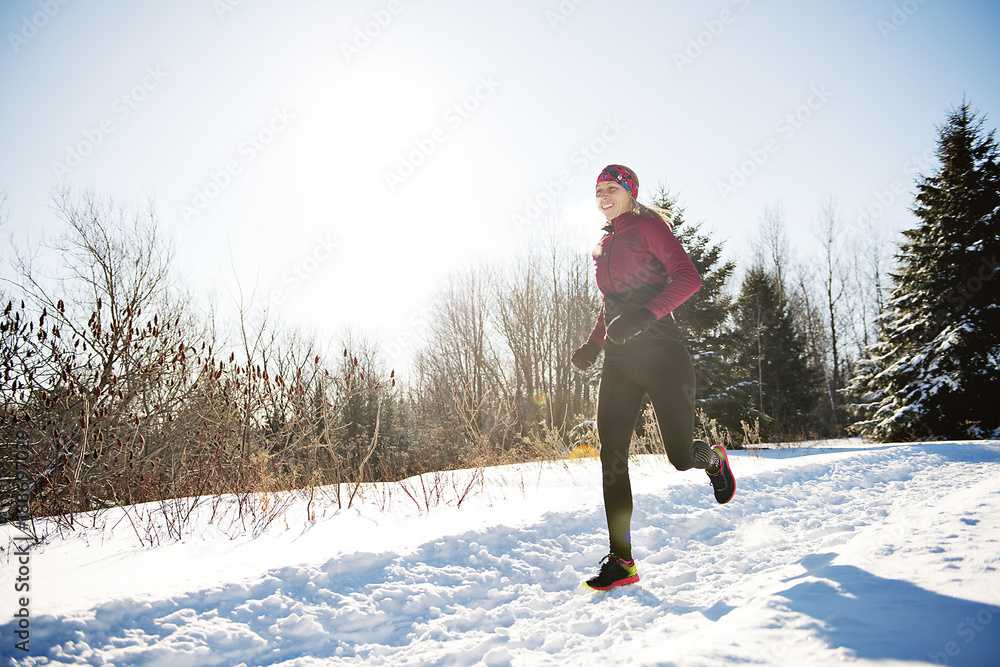 Woman Running in Snowy Park