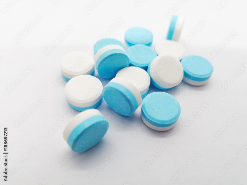 Medication concept. Paracetamol is relief pain drug, double layers blue-white  tablets. Selective focus, isolated on white background and copy space.  Stock Photo | Adobe Stock