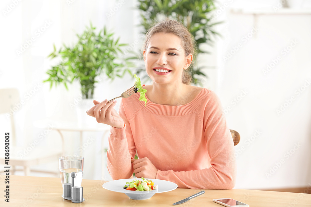 Young beautiful woman eating fresh salad at home Young beautiful woman eating fresh salad at home