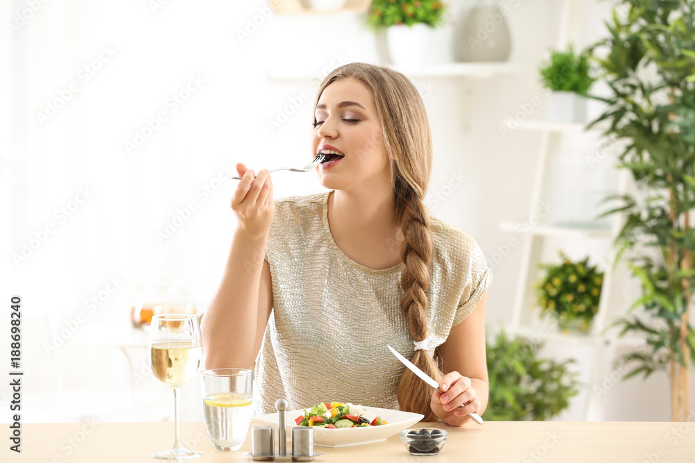 Young beautiful woman eating fresh salad at home Young beautiful woman eating fresh salad at home