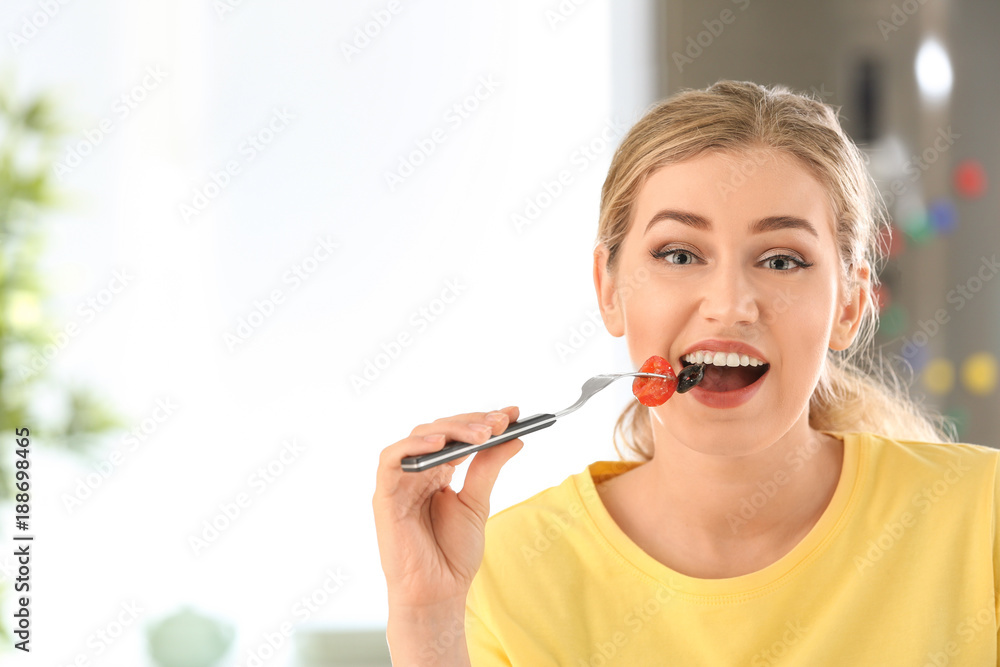 Young beautiful woman eating fresh salad in kitchen Young beautiful woman eating fresh salad in kitchen