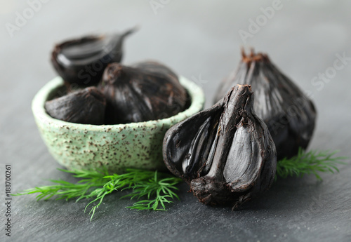 Bowl with black garlic (Allium sativum) on table