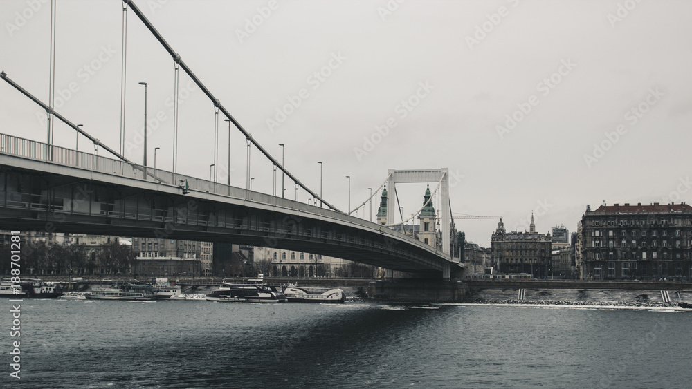 View of the bridge over the Danube river in Budapest, in the background old vintage house. Photo in retro style