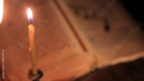 light a candle above the hymn with a silver cross on a chain.