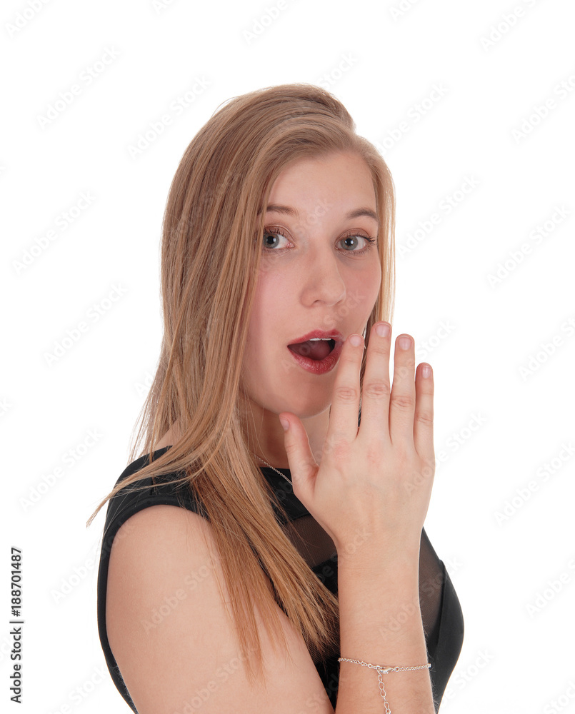Woman telling an secret behind her hand Woman telling an secret behind her hand