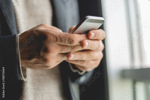 Businessman Typing on smart phone