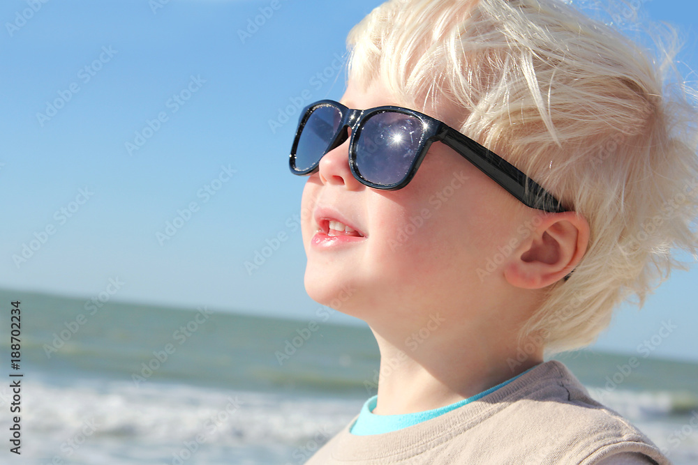 Happy Young Child Facing the Sun on Beach Happy Young Child Facing the Sun on Beach