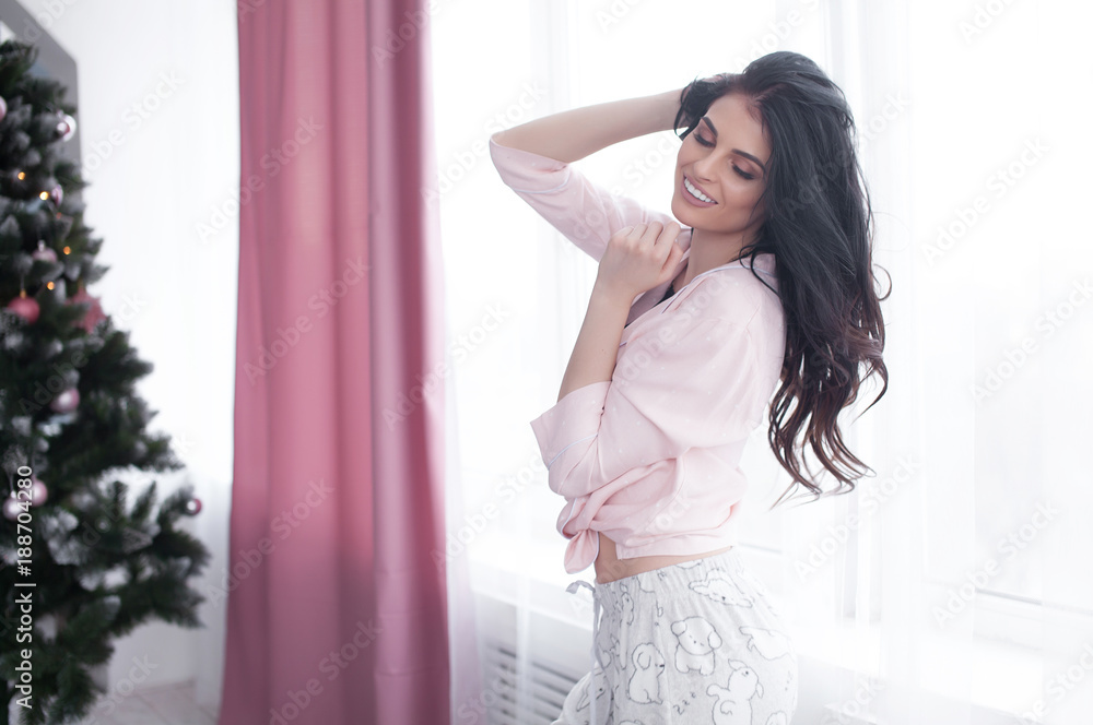 Young attractive female laughing happily in pajama. Young attractive female laughing happily in pajama.