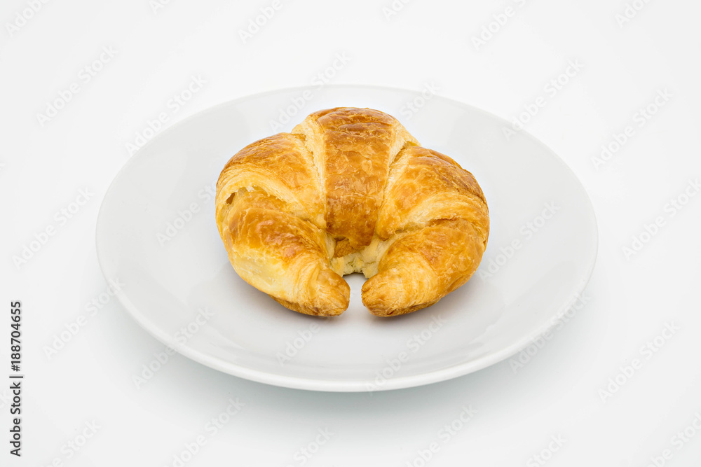 croissant on white plate.