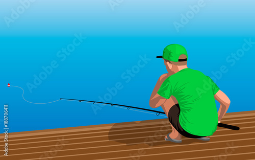 Boy in the green shirt and black shorts is sitting on the dock with a fishing rod. Fishing from the pier into the sea or a river shore