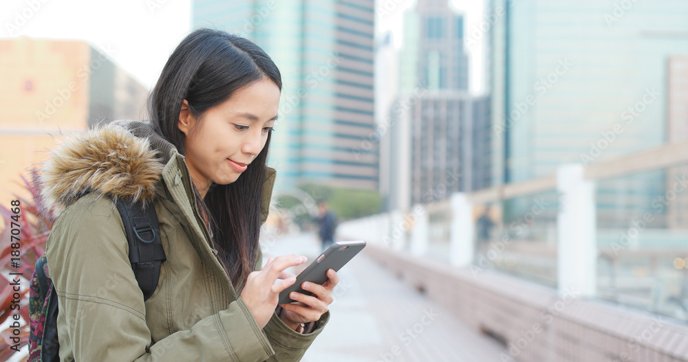 Travel woman use of smart phone for checking information in the city Travel woman use of smart phone for checking information in the city