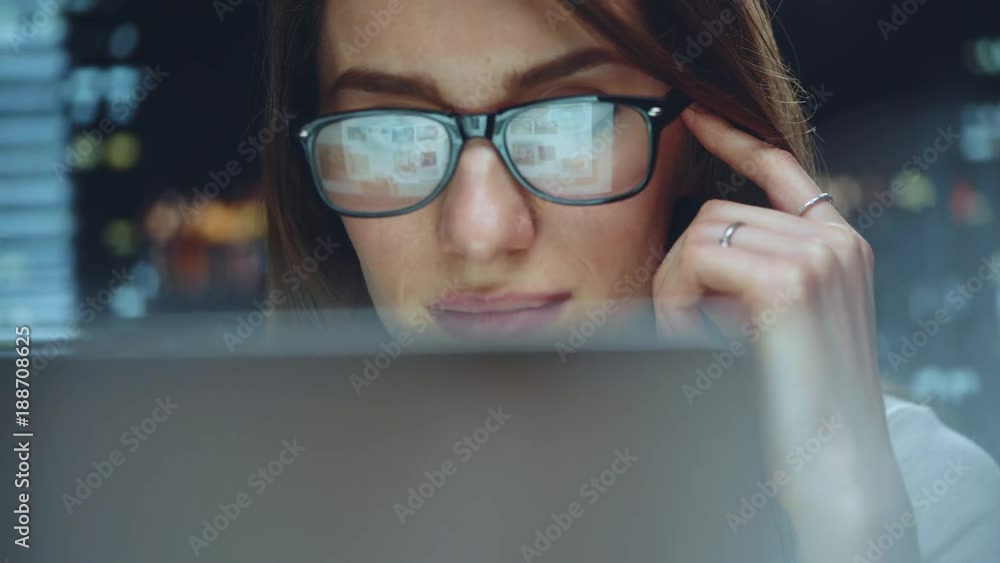 Smiling businesswoman working at modern office and using computer touchscreen, beautiful female manager using laptop looking at monitor