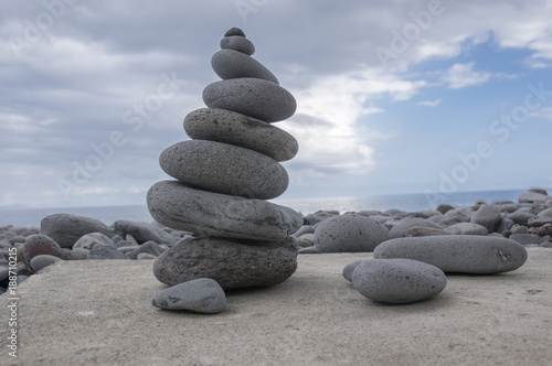 Stone cairn tower, poise stones, rock zen sculpture, light grey pebbles